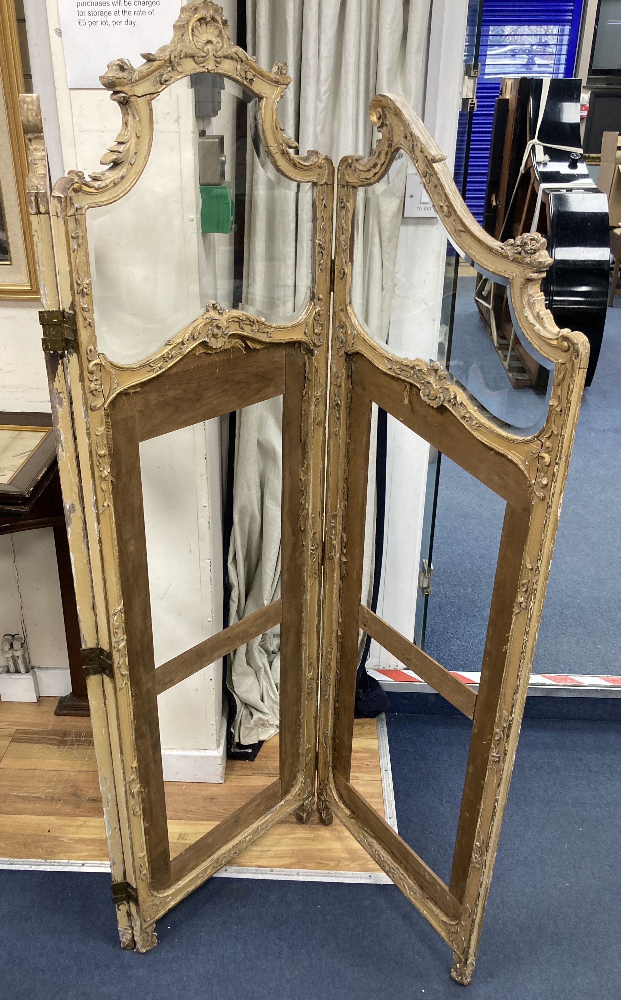 An early 20th century giltwood and gesso part glazed three fold dressing screen, height 172cm